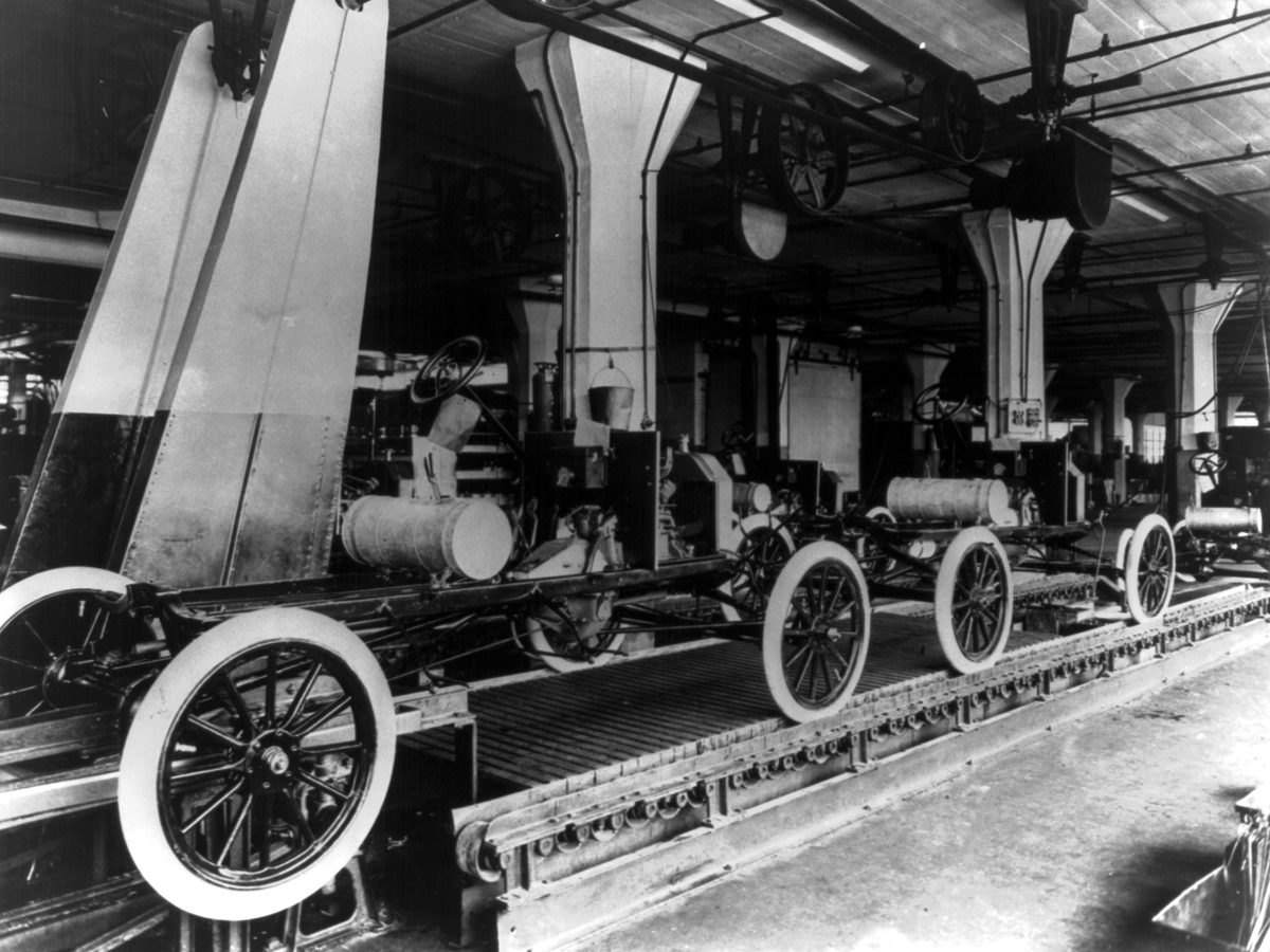 Model T chassis moving down an assembly line at Ford’s Highland Park plant in 1913.